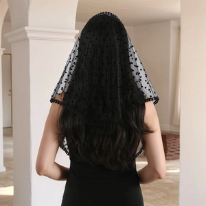 Vintage black polka dot lace veil with pom-pom trim shown from a back view