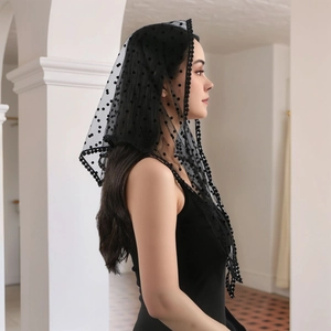 Close-up of black polka dot lace mantilla with elegant round floral embroidery edges