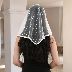 Detailed back view of white polka dot lace headscarf with floral embroidery edges