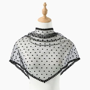 Elegant black polka dot lace shawl featuring a sheer mesh stand collar and pom-pom trim