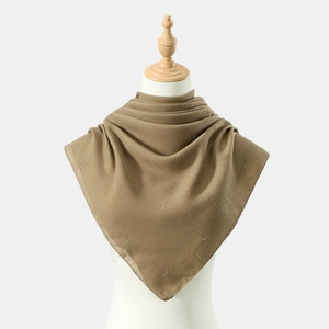 Khaki Muslim hijab shawl with sparkling rhinestones on breathable fabric on mannequin