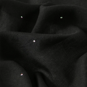 Macro shot of black square scarf fabric with sparkling AB crystals and soft silk texture