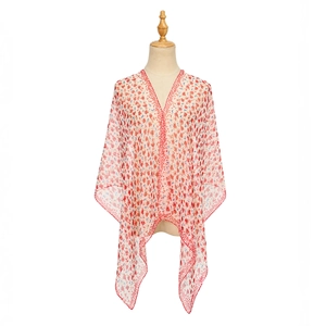 Detail of floral chiffon shawl featuring delicate red and blue flowers with red stitched hem