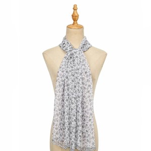 Detail of floral chiffon scarf showing lightweight translucent fabric and black plant patterns