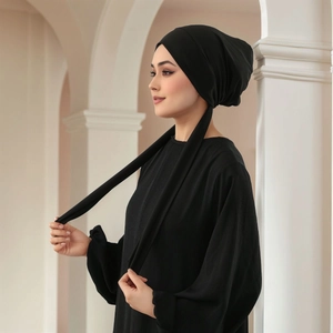 Detail of elegant black pleated hijab scarf showing fine texture and wrapped styling