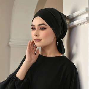 Detail of elegant black pleated hijab in soft crystal hemp fabric worn by a model