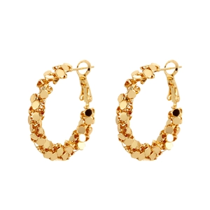 Golden geometric hoop earrings with textured honeycomb pattern on white background