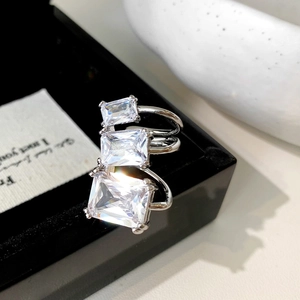 Macro view of three graduated emerald-cut cubic zirconia stones on silver band