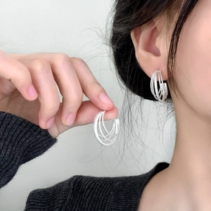 Chic silver multi-layered C-shaped hoop earrings with textured finish and elegant design