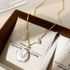 Baroque freshwater pearl pendant necklace on gold chain in a luxury velvet jewelry box