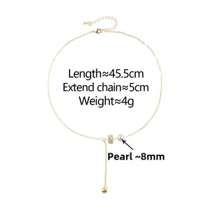 Detail showing shell pearl pendant and zircon micro-pave cylinder on gold chain