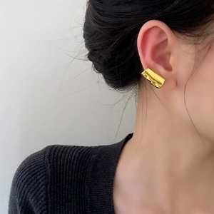 Minimalist gold ear cuff for women with a sleek mirror finish tubular design