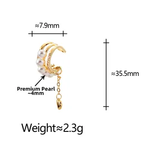 Detailed view of layered gold ear cuff with lustrous pearls and heart tassel pendant