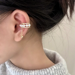 French style gold ear cuff with pearls, rhinestones and heart tassel on a model's ear