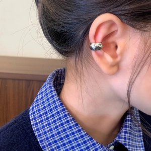 Minimalist silver irregular textured ear cuff with modern hammered liquid metal effect