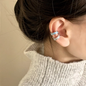 Elegant double-layered zircon ear cuff with blue stones on model in natural light