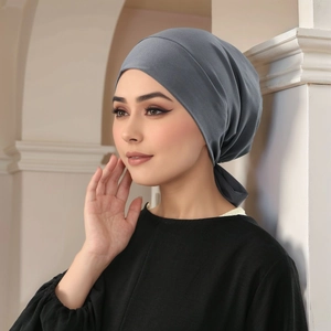 Detail of grey pleated hijab showing soft fabric texture and secure back-tie fastening