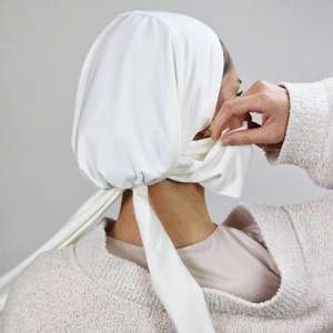Detail view of the pleats and back long ties of this solid white minimalist hijab