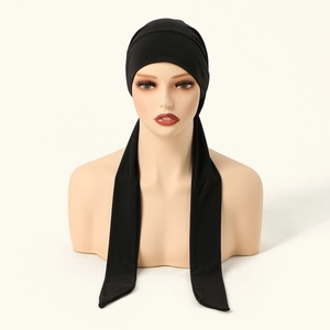 Detail of black pleated headscarf with long flowing ribbons and silky texture