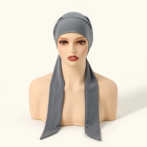 Detail of dark grey pleated hijab cap with long ties on a mannequin display
