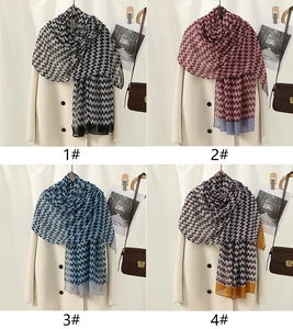Detail showing four color options of houndstooth pattern shawls with elegant drape