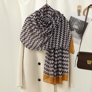 Detail of floral print voile scarf with black and white houndstooth and orange borders