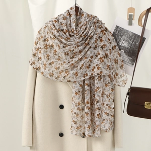 Floral print voile scarf with elegant brown floral patterns styled on beige coat