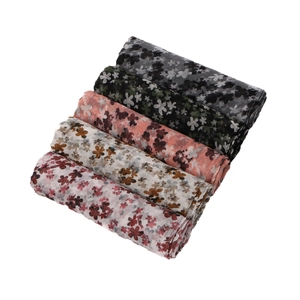 Five assorted floral print voile scarves stacked on a white background for sun protection