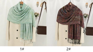 Detail of paisley pattern shawls with tassels in turquoise and maroon styles