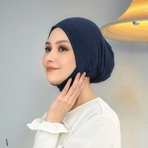 Detail of navy blue turban hat showing elastic texture and smooth premium fabric