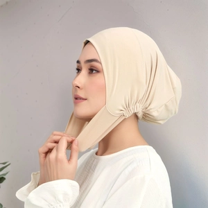 Beige elastic milk silk inner hijab cap with neck cover shown in a side profile view