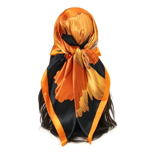 Detail of a floral satin square scarf tied as a headwrap on a mannequin with long hair