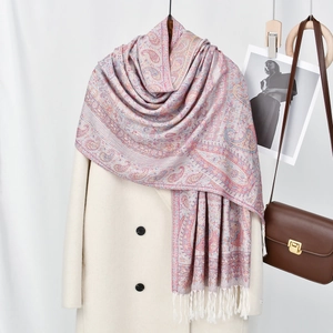 Ethnic paisley print long scarf with tassels draped over a coat for a stylish spring look