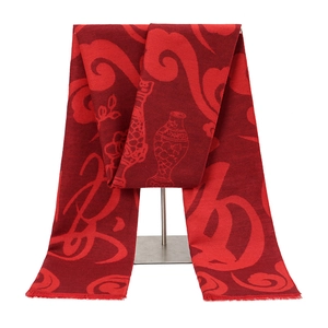 Detail of red polyester scarf with traditional Chinese patterns and fringe tassels