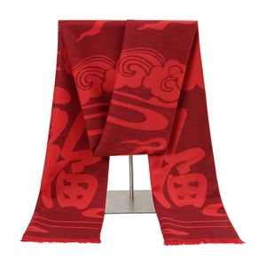 Detail of red polyester scarf with Fu character jacquard pattern and tassel edges