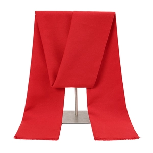 Detail view of red festive scarf featuring smooth texture and fine tassel edges