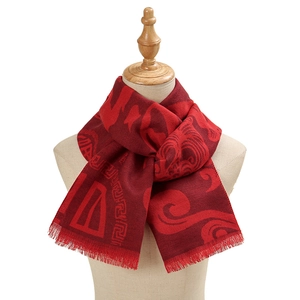 Chinese red festive scarf with traditional patterns and fringes on a mannequin