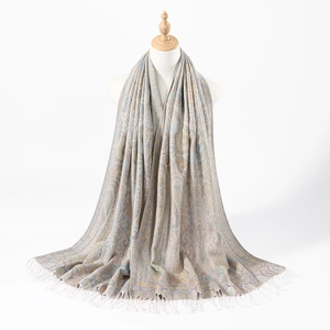 Detail of bohemian paisley jacquard scarf showing intricate pattern and white fringe tassels