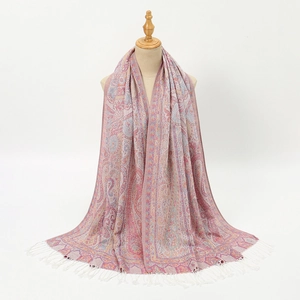 Detail of bohemian paisley jacquard shawl with decorative white fringe tassels