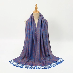 Detail of vintage paisley pattern and navy tassels on a long bohemian pashmina scarf