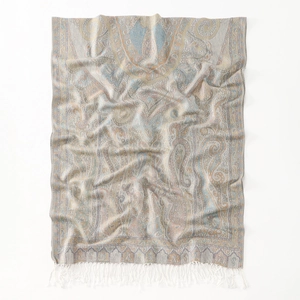 Detail of paisley pattern and white tassel trim on a soft polyester bohemian scarf
