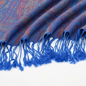 Detail of dark blue paisley jacquard shawl with colorful patterns and handmade tassels