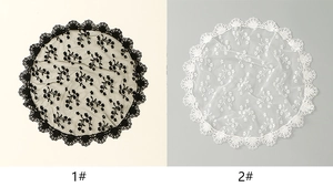 Detail view of round lace embroidery veils in black and white with floral patterns