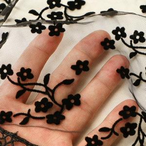 Elegant black embroidered lace veil with floral patterns and sheer mesh fabric