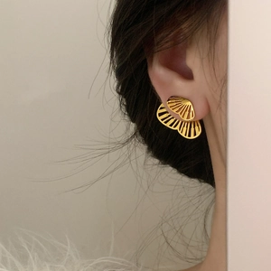Elegant gold hollow fan-shaped ginkgo leaf stud earrings for a minimalist look