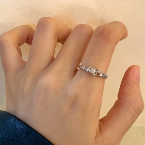 Minimalist silver star and planet open ring with sparkling crystals on female hand