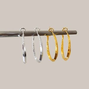 Minimalist geometric hoop earrings with textured finish in gold and silver options