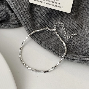 Detailed view of silver multifaceted beads bracelet with extension chain and pendant