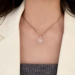 Elegant rose gold clover necklace with zircon micro-paving worn on neck for a chic look