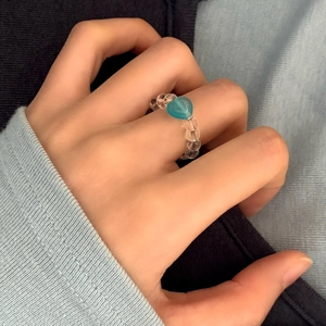 Handmade beaded ring with clear round beads and a turquoise heart-shaped charm